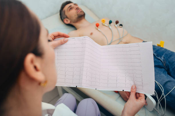 Doctor reading an ECG for a monitored patient
