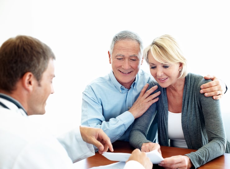 Doctor reviewing documents with a senior couple